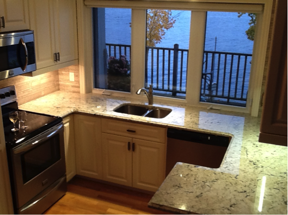 Light Coloured Granite Enlarges The Look of a Small Kitchen